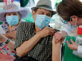 A man receives a dose of the AstraZeneca COVID-19 vaccine, during a mass vaccination program in Monterrey, Mexico April 12, 2021.