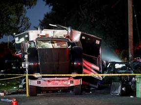 A damaged vehicle is seen at the site of an explosion after police attempted to safely detonate illegal fireworks that were seized, in Los Angeles, Calif., June 30, 2021.