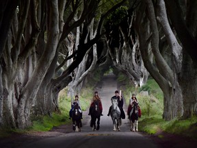 Four actors on horseback dressed in Game of Thrones related costumes carry the Queen's Baton as they make their way way along the Dark Hedges on August 29, 2017 in Antrim, Northern Ireland.