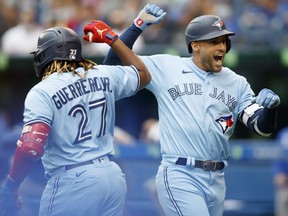 Blue Jays' George Springer (right) celebrates a home run with teammate Vladimir Guerrero Jr. (27) in the first inning  against the Royals at Rogers Centre in Toronto, Saturday, July 31, 2021.