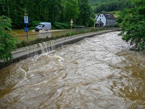 The flooded Volme River is pictured on July 15, 2021 in Priorei near Hagen, western Germany, after heavy rain hit parts of the country, causing widespread flooding.