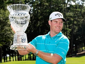 Grayson Murray of the United States celebrates with the trophy after winning on the 18th green during the final round of the Barbasol Championship at the Robert Trent Jones Golf Trail at Grand National on July 23, 2017 in Auburn, Ala.