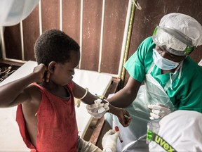 Blood samples are drawn from a boy who didn't display any sign of monkeypox despite his all family has been contaminated, while at a quarantine area of the centre of the International medical NGO Doctors Without Borders (Medecins sans frontieres - MSF), in Zomea Kaka, in the Lobaya region, in the Central African Republic on October 18, 2018.