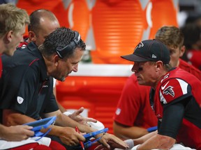 Matt Ryan, right, of the Atlanta Falcons speaks with quarterbacks coach Greg Knapp during the first half of an NFL preseason game against the New York Jets at Mercedes-Benz Stadium on Aug. 15, 2019 in Atlanta, Ga.