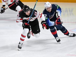 Defenceman Owen Power (left), battling USA forward Tage Thompson for the puck during their  world championship semifinal in Latvia Latvia, last month, was the first overall pick of the Buffalo Sabres in the 2021 NHL draft.