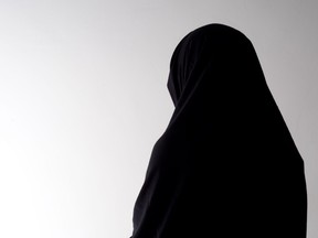 Woman in chador from behind, with copyspace.