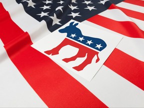 Series of USA ruffled flags with democratic party symbol over it