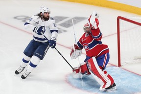 Tampa Bay Lightning left wing Pat Maroon (14) skates in front as Montreal Canadiens goaltender Carey Price (31) makes a glove save during the third period in game four of the 2021 Stanley Cup Final at Bell Centre July 5, 2021.