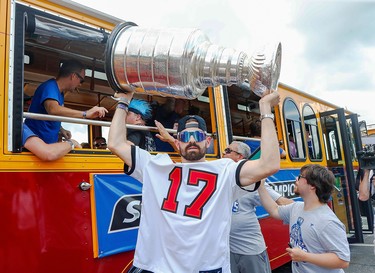 Tampa Bay Lightning left wing Alex Killorn (17) hoists the Stanley Cup during the Stanley Cup Championship parade. Mandatory Credit: Kim Klement-USA TODAY Sports ORG XMIT: IMAGN-455511