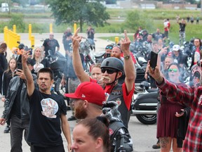 A large crowd gathered at London's provincial jail, the Elgin-Middlesex Detention Centre, to mark the death of inmate Brandon Marchant, 32. Here, some in the crowd are seen giving the middle finger to the jail. Photo taken Saurday July 17, 2021. Dale Carruthers/The London Free Press