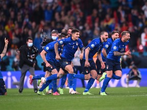 Italy players celebrate reaching the final after winning the penalty shootout.