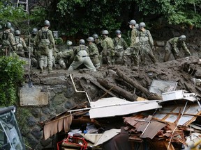 Members of Japanese Self-Defence Forces conduct rescue and search operation at a mudslide site caused by heavy rain at Izusan district in Atami, west of Tokyo, Japan, Monday, July 5, 2021.