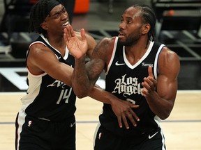 Los Angeles Clippers guard Terance Mann, left, and forward Kawhi Leonard react against the Dallas Mavericks during the second half in game seven of the first round of the 2021 NBA Playoffs. at Staples Center in Los Angeles, June 6, 2021.