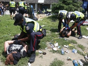 Toronto Police make arrests as city crews moved in to clear a homeless encampment on the west side of Lamport Stadium on July 21, 2021.