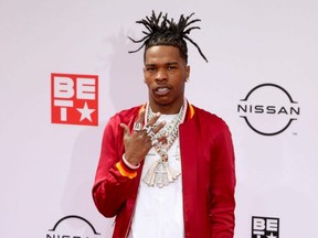 Lil Baby poses on the red carpet as he arrives for the BET Awards at Microsoft Theater in Los Angeles, June 27, 2021.