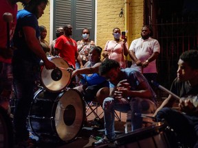 A band plays for the crowd on Bourbon Street as Louisiana's COVID-19 cases rise amid Delta variant, in New Orleans, La., July 23, 2021.