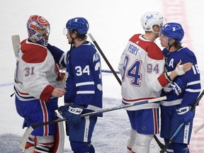 Maple Leafs forwards Auston Matthews (34) and Mitch Marner shake hands with Montreal Canadiens goalie Carey Price (31) and forward Corey Perry after the Canadiens eliminated the Leafs from the Stanley Cup playoffs. Toronto will open its pre-season schedule on Saturday Sept. 25 against Montreal at, Scotiabank Arena.