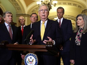 U.S. Senate Minority Leader Sen. Mitch McConnell (R-KY), centre, speaks as (left to right) Sen. Roy Blunt (R-MO), Sen. Rick Scott (R-FL), Sen. John Barrasso (R-WY), Senate Minority Whip Sen. John Thune (R-SD) and Sen. Joni Ernst (R-IA) listen during a news briefing after a weekly Senate Republican Policy Luncheon at the U.S. Capitol on July 27, 2021 in Washington, D.C.