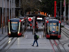 A man wearing a mask walks towards the tram station at Circular Quay in Sydney on July 19, 2021, amid a lockdown in Melbourne and Sydney.