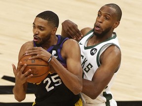 Khris Middleton of the Milwaukee Bucks (right) guards Mikal Bridges of the Phoenix Suns in the first half of Game Two of the NBA Finals at Phoenix Suns Arena on July 8, 2021 in Phoenix, Ariz.