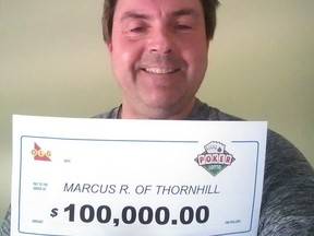 Marcus Ridgway, 57, of Thornhill, picks up his $100,000 Poker Lotto prize.