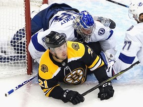 Andrei Vasilevskiy of the Tampa Bay Lightning lands on top of Nick Ritchie of the Boston at Scotiabank Arena on August 5, 2020 in Toronto.