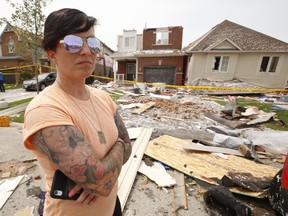 A tornado tore through a neighbourhood in the southeast end of Barrie on Thursday damaging at least 150 homes. Natalie Harris is seen here outside her ex-husband's home on Majesty Blvd., where she managed to hide in the home's basement with her son and two dogs just before the tornado hit, on Friday July 16, 2021.