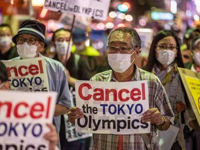 A group of anti-Olympic activists march to the offices of the Tokyo Organizing Committee of the Olympic and Paralympic Games in Tokyo in July 16, 2021.