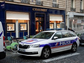 A police vehicle stands outside Chaumet jewelry store that was targeted by a robbery in Paris, France July 27, 2021.