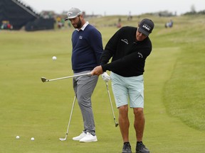Phil Mickelson (right) and Jon Rahm get in some practise on Wednesday for this week's Open Championship at Royal St. George's in southern England.
