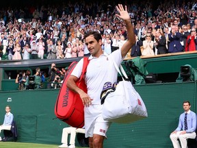 Roger Federer waves to the crowd after losing his Wimbledon quarterfinal match against Hubert Hurkacz at the All England Lawn Tennis and Croquet Club in London, England, on July 7, 2021.