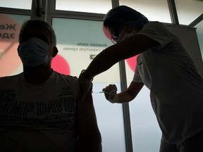 A man receives a dose of Sputnik V (Gam-COVID-Vac) vaccine against COVID-19 in Moscow, Russia, July 15, 2021.