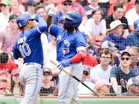 Blue Jays' Marcus Semien  celebrates with teammate Vladimir Guerrero Jr. after hitting a solo home run in the second inning against the Boston Red Sox at Fenway Park on June 13, 2021 in Boston.