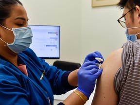 Nurl Anisah, a nurse at StarMed Specialist Centre, administers the Sinovac vaccine to man in Singapore, July 13, 2021.