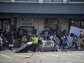 Rioters loot the Jabulani Mall in the Soweto district of Johannesburg on July 12, 2021.