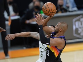 Phoenix Suns guard Chris Paul (3) shoots against Milwaukee Bucks guard Jeff Teague (5) during Game 2 of the NBA Finals at Phoenix Suns Arena.