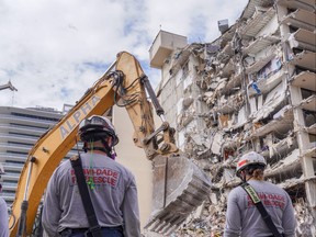 Miami Dade Fire Department crew work at the site of a collapsed Florida condominium complex in Surfside, Miami, in this handout image July 2, 2021.