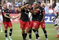 D.C. United’s Yamil Asad (centre left) celebrates with teammates after scoring against Toronto FC in Washington yesterday. Toronto FC lost in a blowout 7-1.  Will Newton/AP