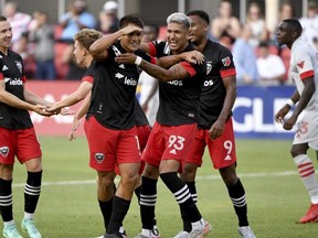 D.C. United’s Yamil Asad (centre left) celebrates with teammates after scoring against Toronto FC in Washington yesterday. Toronto FC lost in a blowout 7-1.  Will Newton/AP