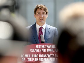 Prime Minister Justin Trudeau answers questions from reporters following a transit announcement during a press conference at Surrey City Hall in Surrey, B.C., on Friday, July 9, 2021.