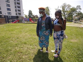 Cheyene Kelly, age 12, and her mom Jacqueline McKnight stand at the area where they saw from their balcony that a 12-year-old boy was shot twice in the leg on Friday night around 11 p.m. near a children's playground located on Falstaff Ave. Cheyenne said the boy is a friend and she used to go to school with him.   on Saturday July 31, 2021. Jack Boland/Toronto Sun/Postmedia Network