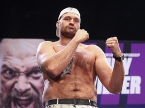 Tyson Fury steps up for a face off with Deontay Wilder at the press conference at The Novo by Microsoft at L.A. Live on June 15, 2021 in Los Angeles.