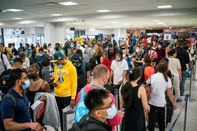 Travellers wait in line for immigration process ahead of the July 4th holiday, at the Newark Liberty International Airport, in Newark, New Jersey, U.S., July 2, 2021.