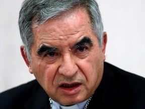 Cardinal Giovanni Angelo Becciu, who has been caught up in a real estate scandal, speaks to the media a day after he resigned suddenly and gave up his right to take part in an eventual conclave to elect a pope, near the Vatican, in Rome, Sept. 25, 2020.