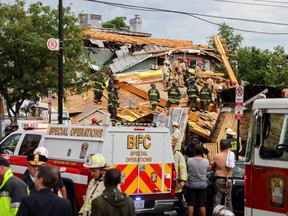 Emergency personnel search for trapped workers after a building undergoing construction collapsed in Washington, D.C., July 1, 2021.
