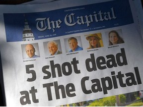 In this file photo The Capital Gazette of June 29, 2018, in Annapolis, Maryland, announces the victims of the June 28 shooting at the media oulet's offices.