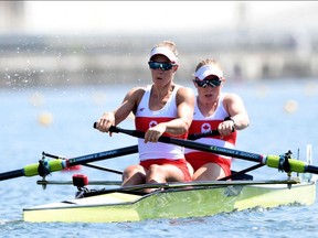 (L-R) Canada's Hillary Janssens and Canada's Caileigh Filmer compete in the women's pair heats during the Tokyo 2020 Olympic Games at the Sea Forest Waterway in Tokyo on July 24, 2021. (Photo by Luis ACOSTA / AFP)