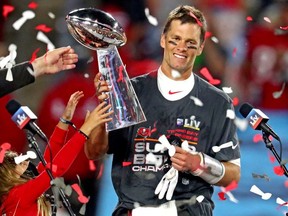 Tampa Bay Buccaneers quarterback Tom Brady (12) celebrates with the Vince Lombardi Trophy after beating the Kansas City Chiefs in Super Bowl LV at Raymond James Stadium.