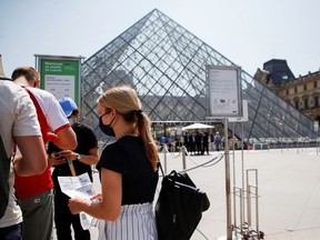 People with health passes wait to enter the Louvre museum in front of the Louvre Pyramid designed by Chinese-born U.S. architect Ieoh Ming Pei amid the coronavirus disease (COVID-19) outbreak in Paris, France, July 21, 2021.
