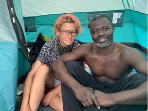 Lewis Oppong and Jennifer Charlevoix are pictured inside their tent in Moss Park on July 26, 2021.